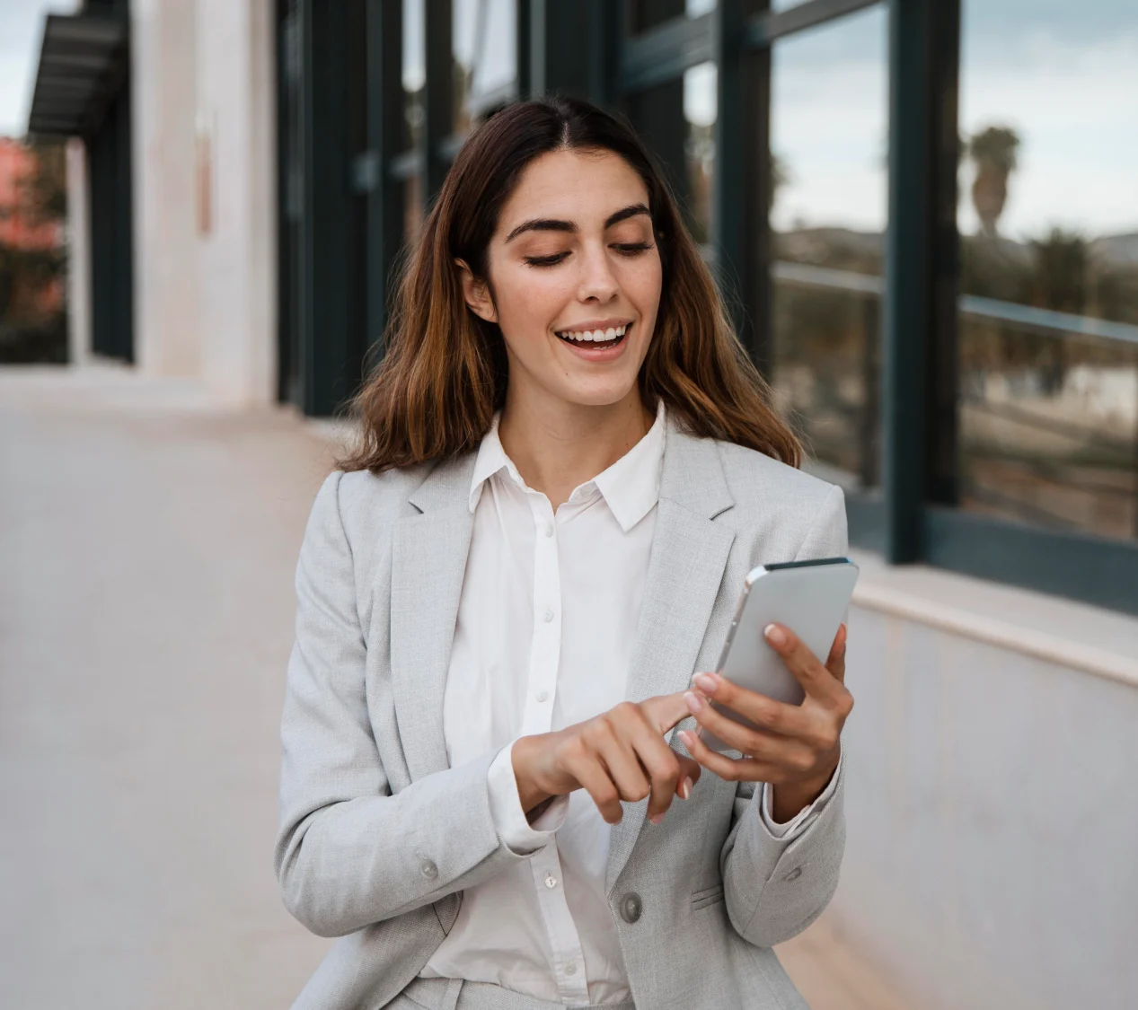 front-view-elegant-businesswoman-using-smartphone-city