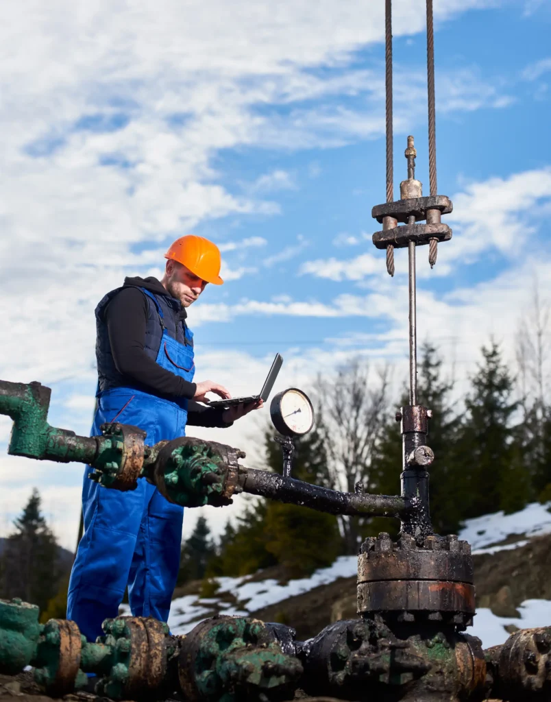 petroleum-engineer-using-laptop-oil-field